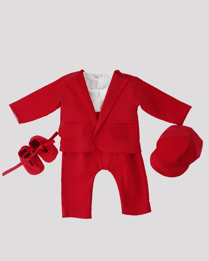A red suit, white shirt, red cap, and red shoes are arranged on a white background.