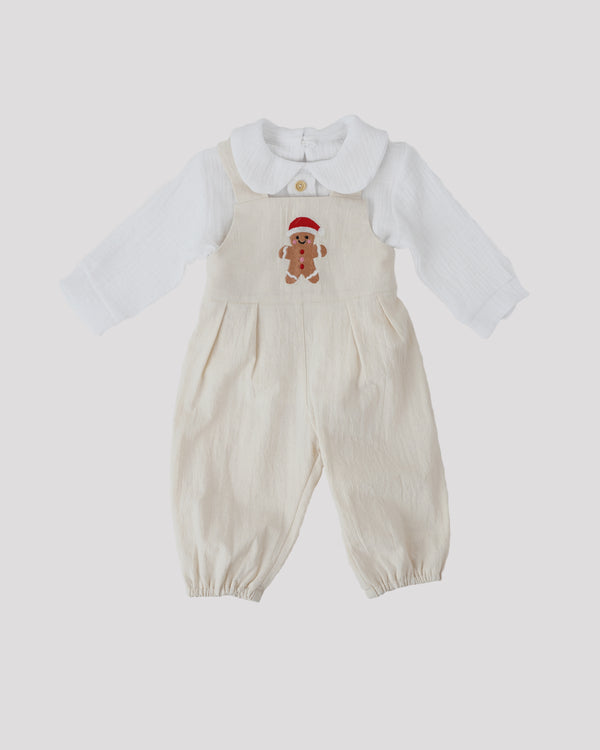 A white onesie with a red and white gingerbread man design on the front.
