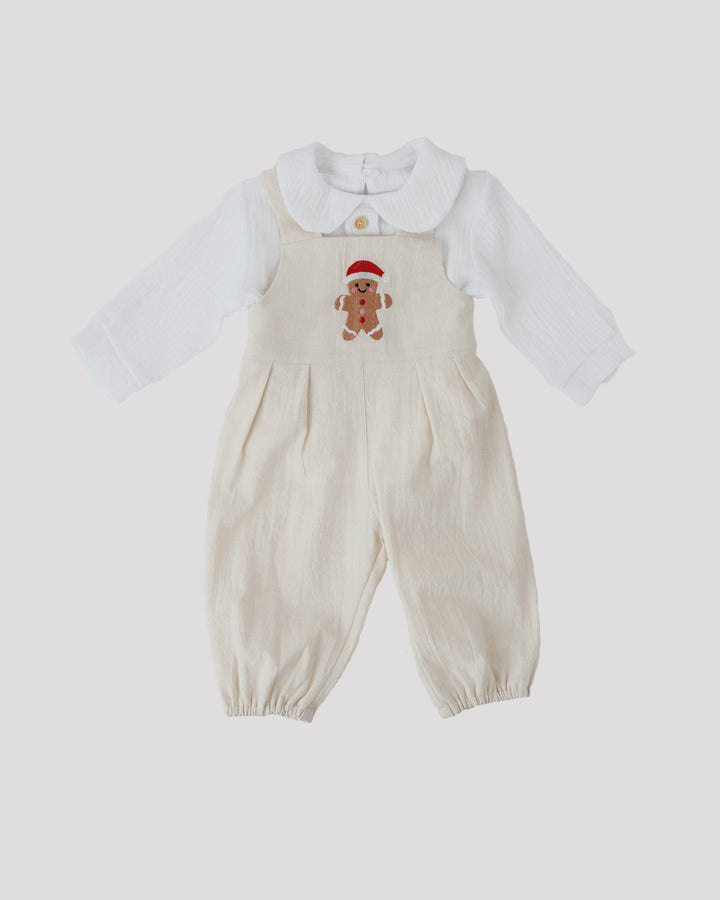 A white onesie with a red and white gingerbread man design on the front.