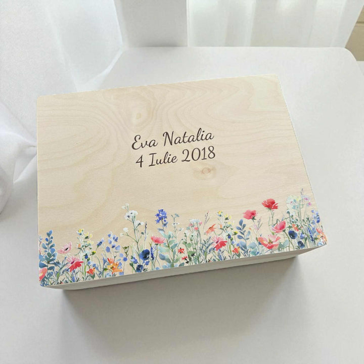 A wooden box with a floral design on the front, featuring the text "Ella Natalie 4 July 2018" printed on it.