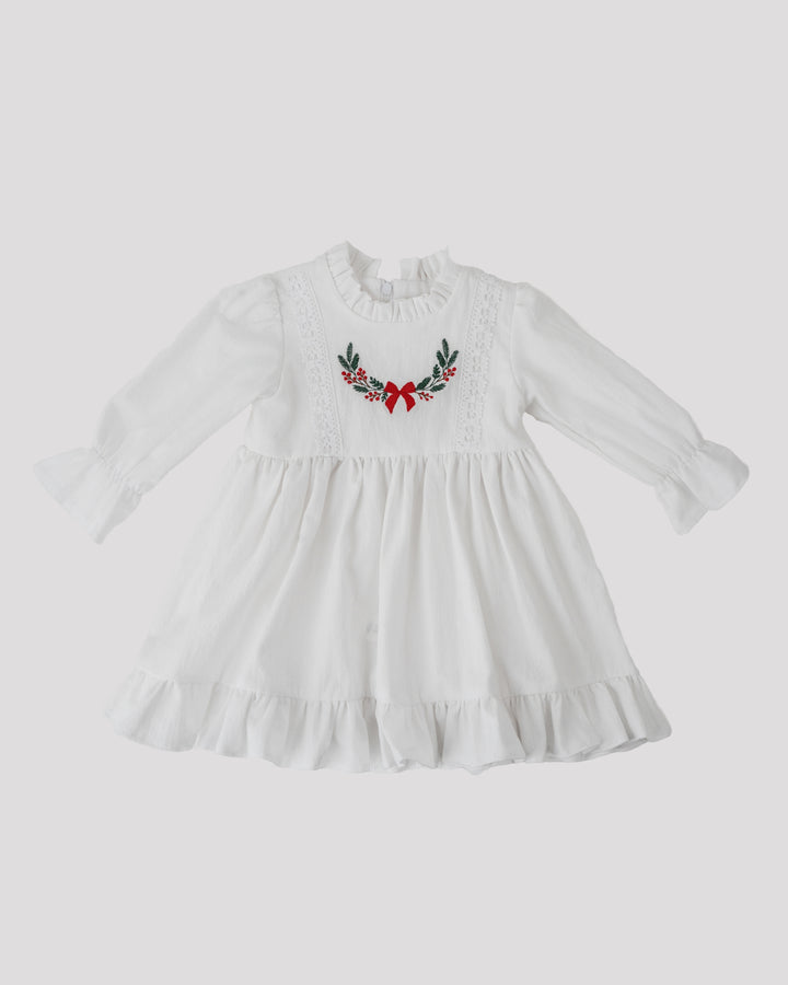 A white dress with a ruffled collar and a floral embroidered design on the front.