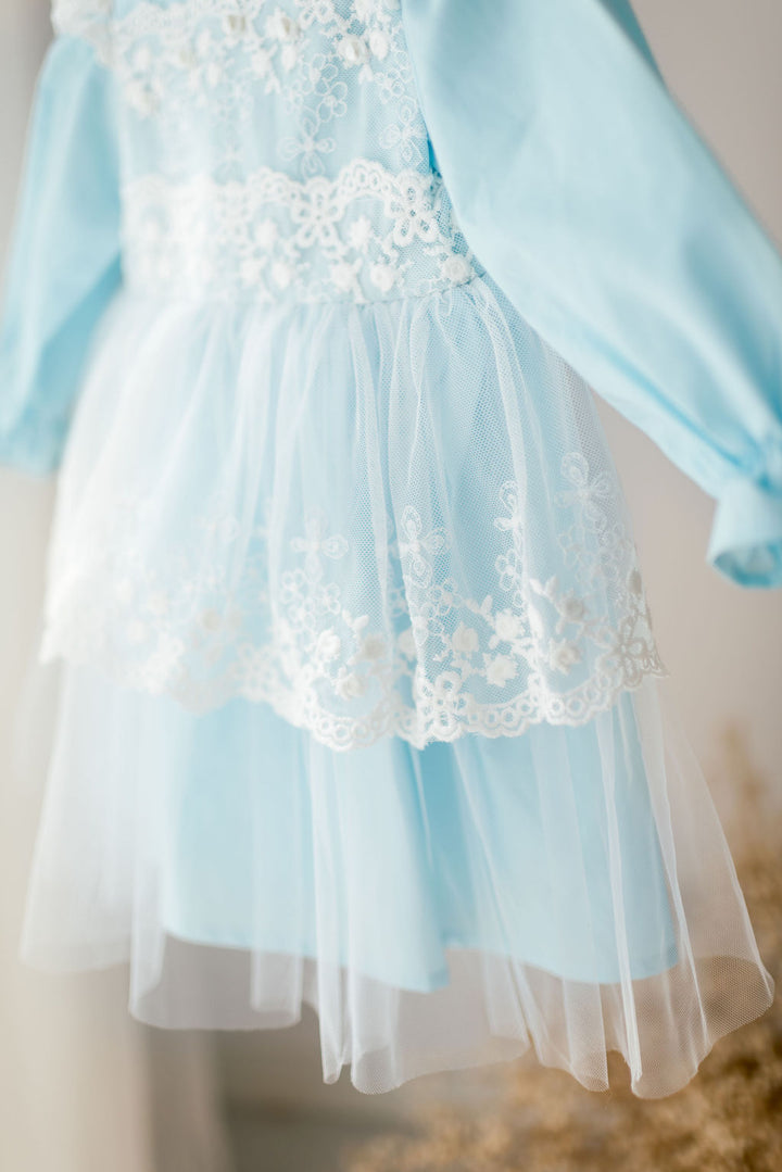 A light blue dress with white lace trim, featuring a full skirt and puffed sleeves.