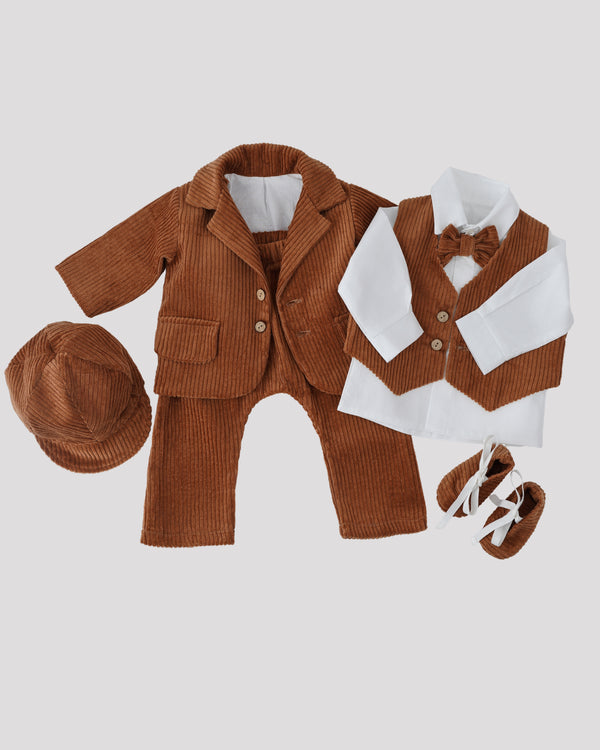 A set of brown corduroy clothing items, including a jacket, pants, and a bow tie, arranged on a plain background.