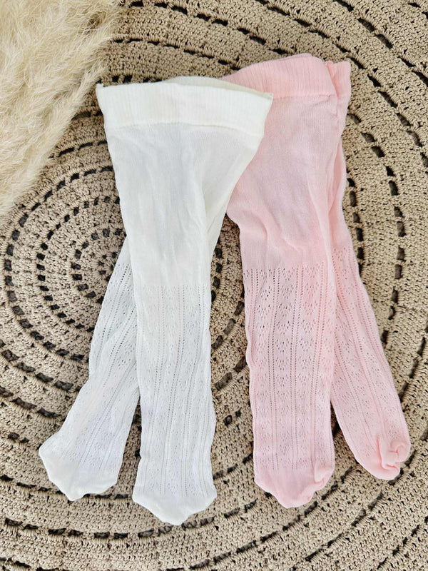 a pair of white tights and a pair of pink tights lying on a circular woven surface.