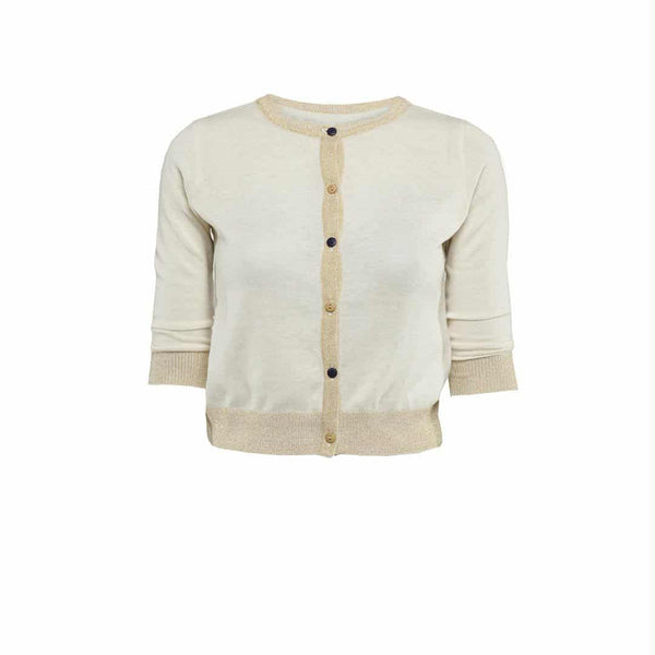 A cream-colored cardigan with gold trim and buttons.