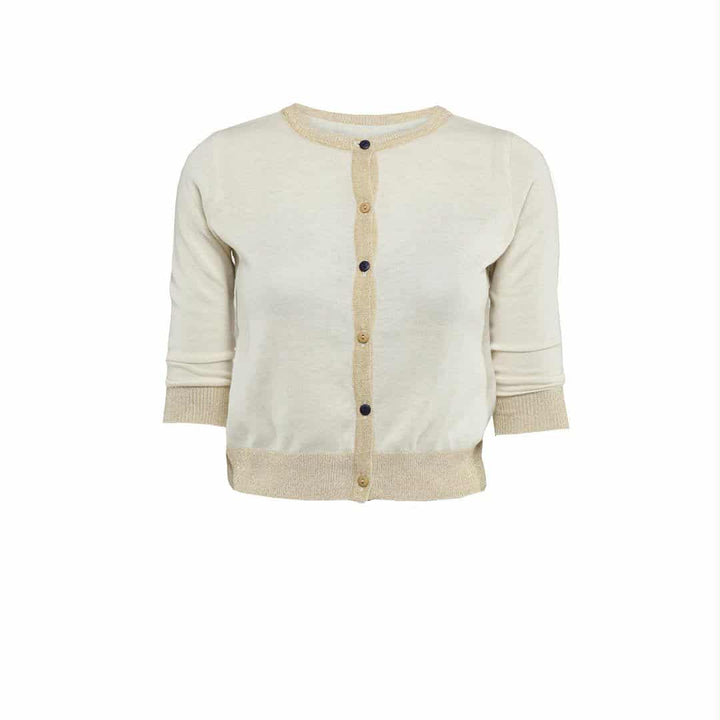A cream-colored cardigan with gold trim and buttons.