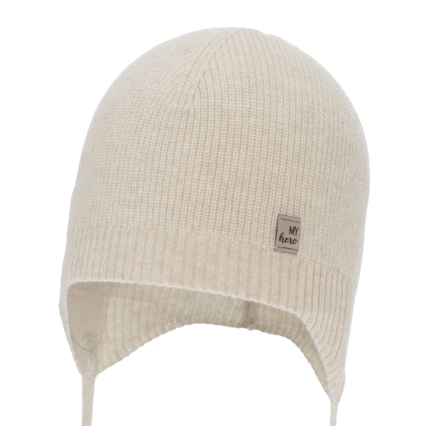 A cream-colored knit hat with a small label on the front.