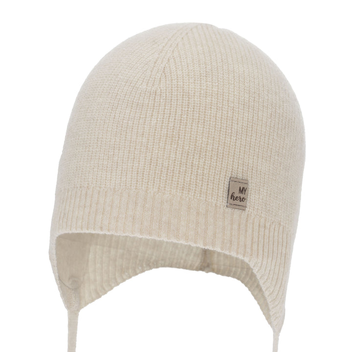 A cream-colored knit hat with a small label on the front.