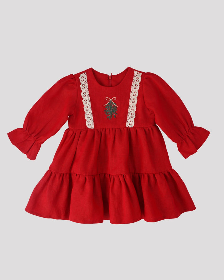 A red, ruffled dress with lace trim, featuring a small embroidered design on the front.