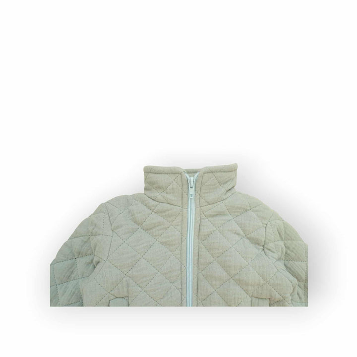 A light green quilted jacket with a white zipper and collar is shown against a white background.
