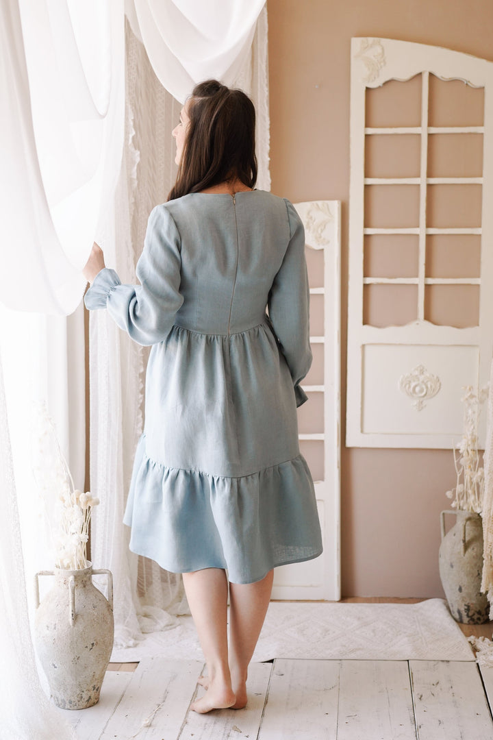 a woman standing in front of a window