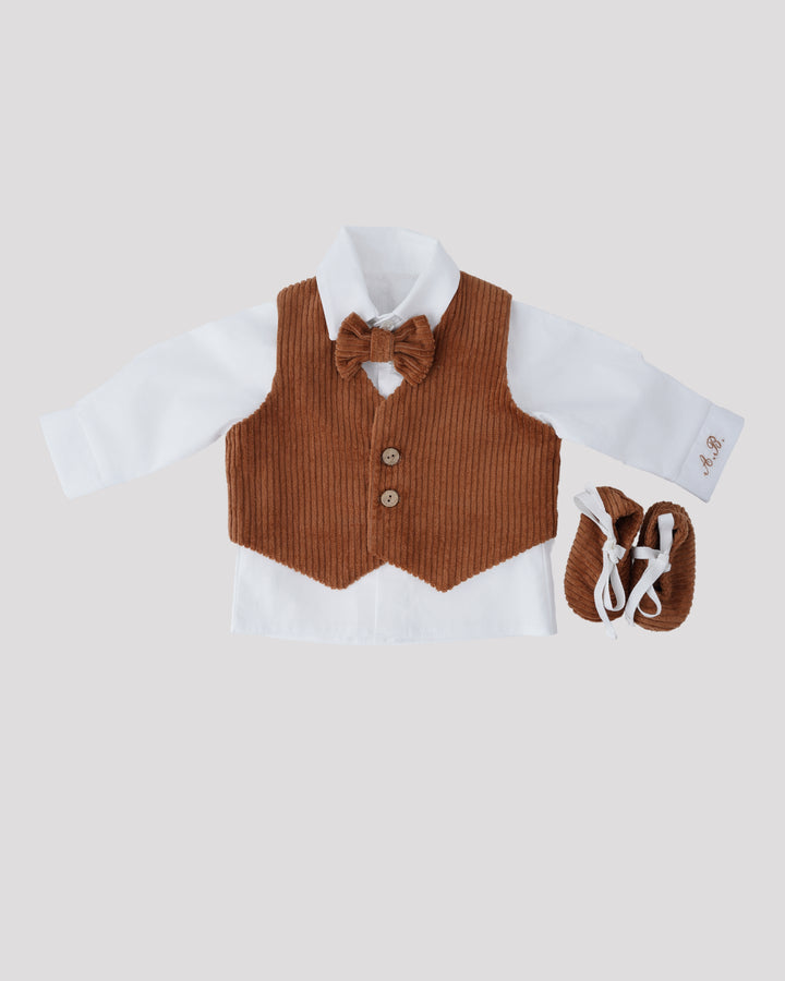 A brown vest, white shirt, and brown bow tie are displayed together, along with a pair of brown shoes.