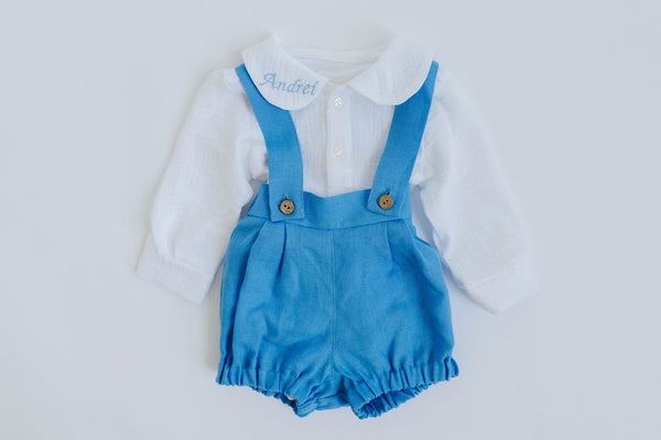 A white shirt with a blue collar and suspenders, with the name "Andrey" embroidered on the shirt collar.