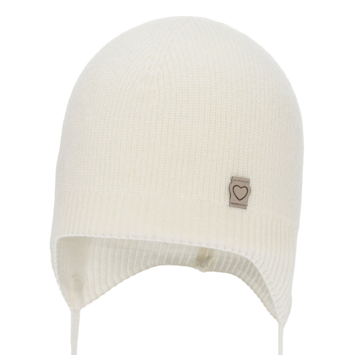 A white knit hat with a small heart-shaped patch on the front.