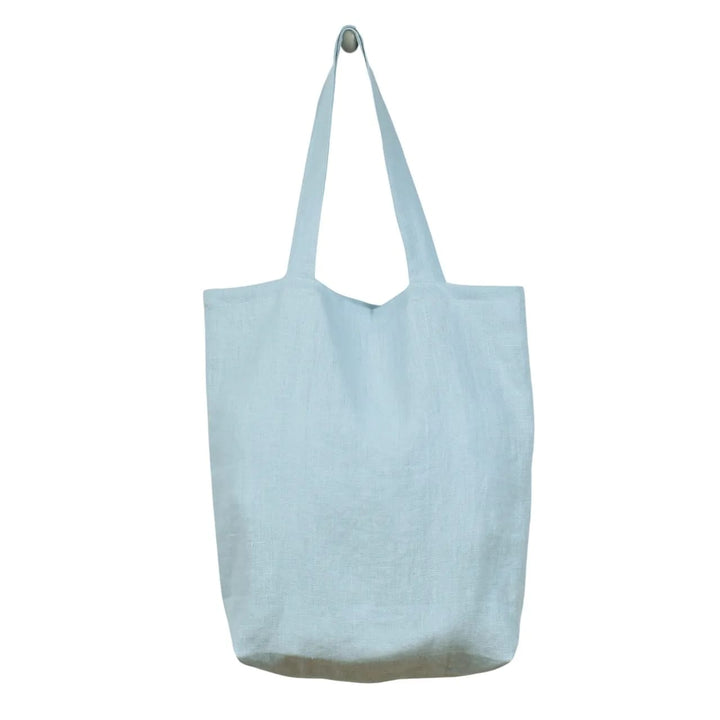 A light blue tote bag hanging against a white background.