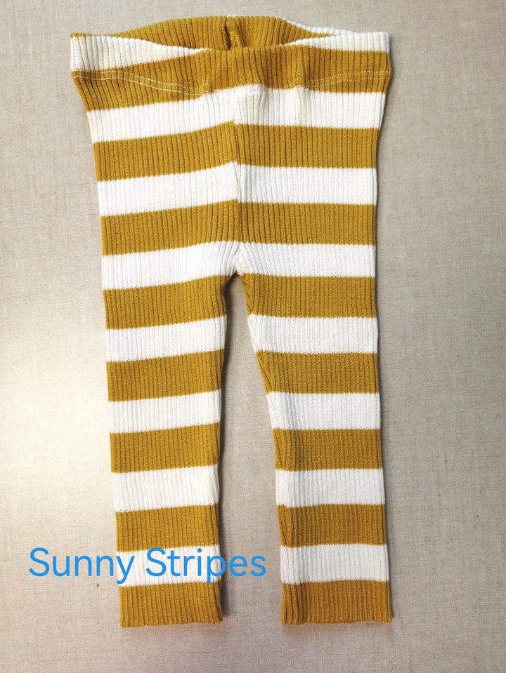 a baby's striped leggings with a bow on the side